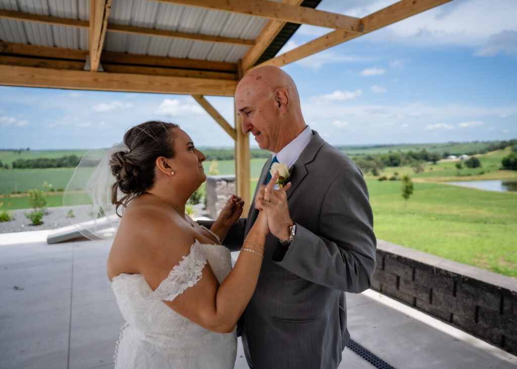 First look with dad at Bluebird Hill Iowa wedding venue