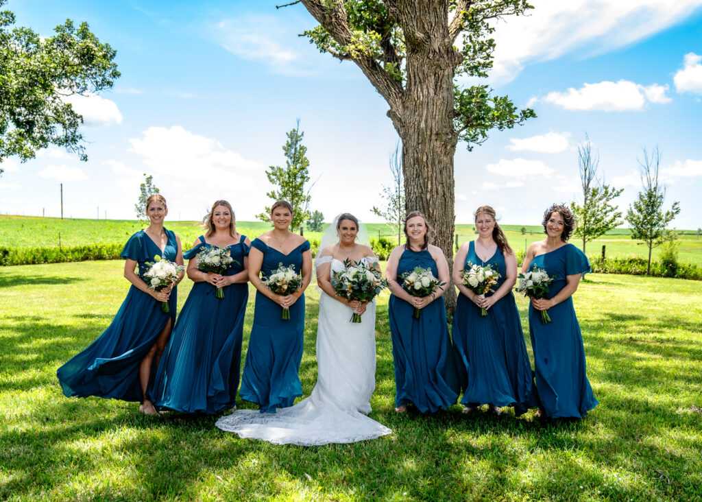 Wedding party photos under the trees at Bluebird Hill Iowa wedding venue