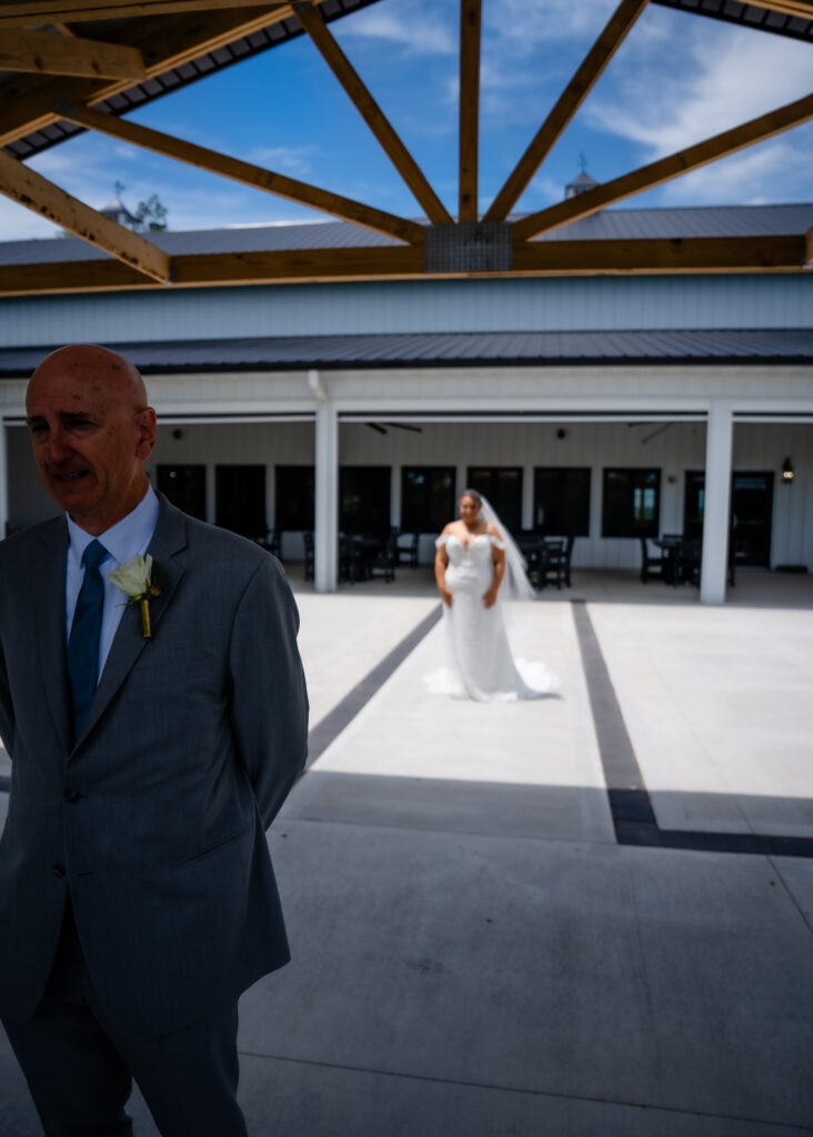 First look with dad outside at Bluebird Hill Iowa wedding venue