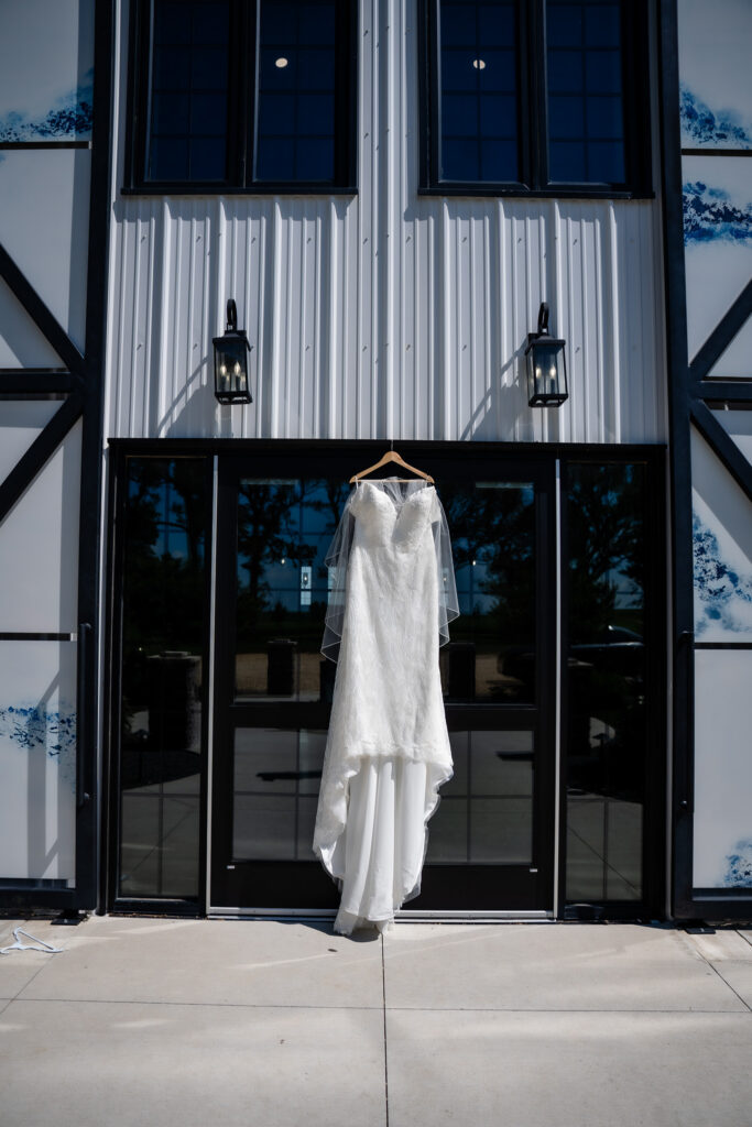 Details photos of dress hanging up at Bluebird Hill Iowa wedding venue