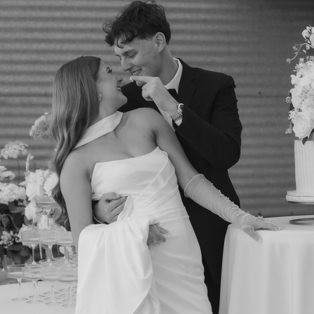 Couple cutting their wedding cake at 1868 Farmhouse Iowa wedding venue