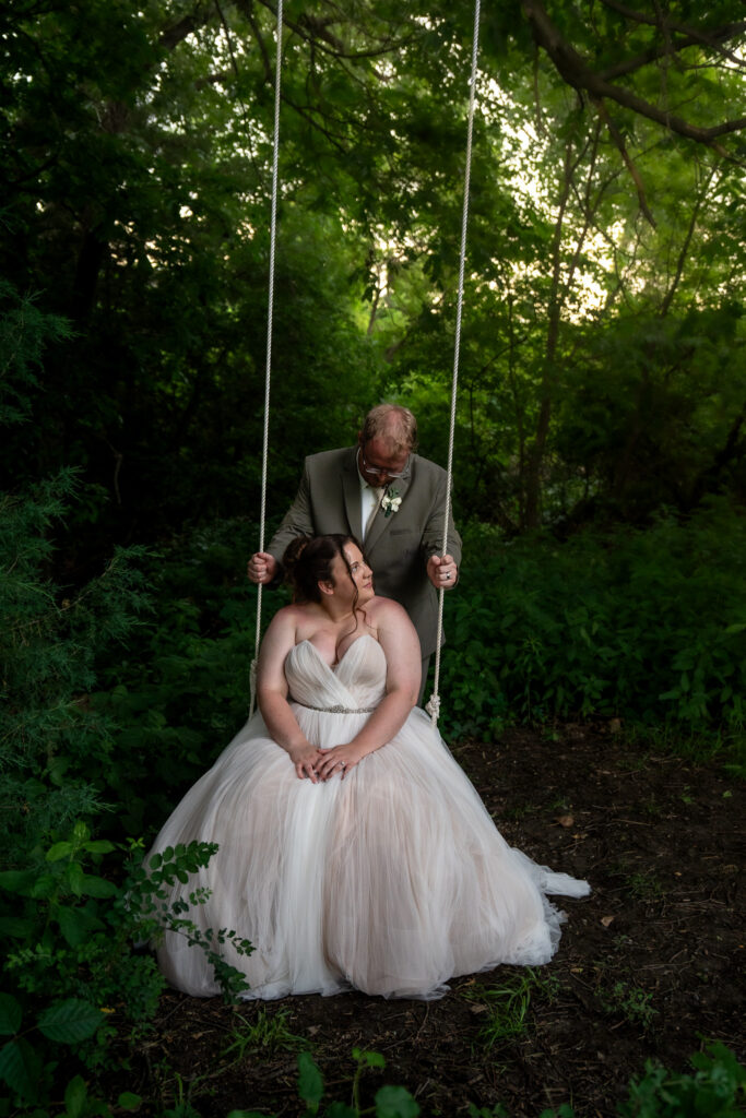 Couples photos on a rope swing at The Vineyard at St. Charles Iowa wedding venue of bride and groom on their wedding day