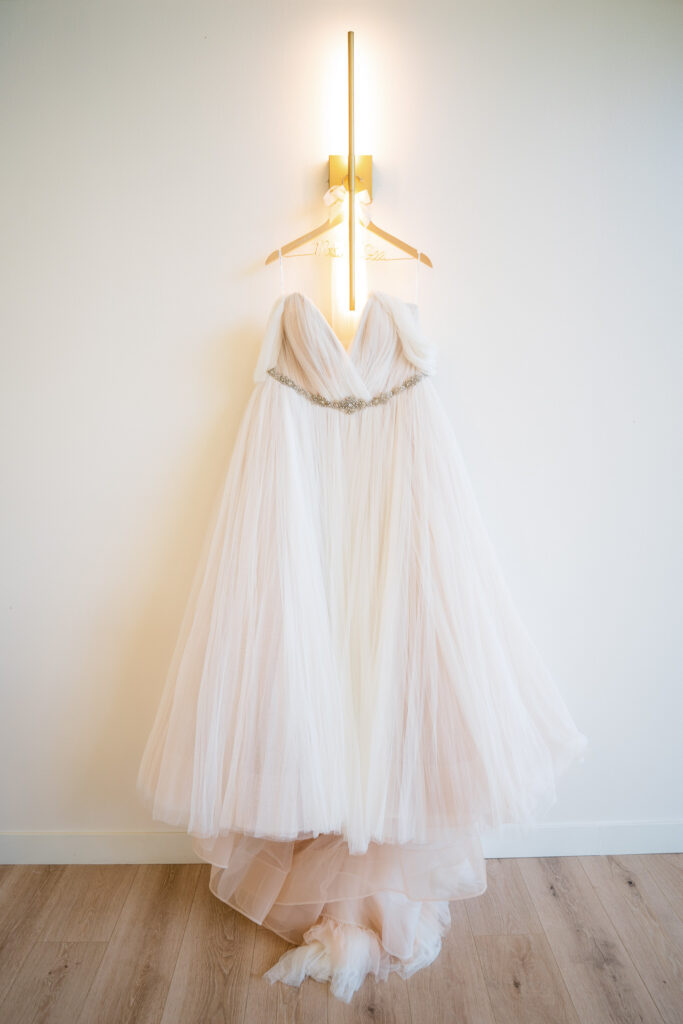 Wedding dress hanging up at The Vineyard at St. Charles Iowa wedding venue